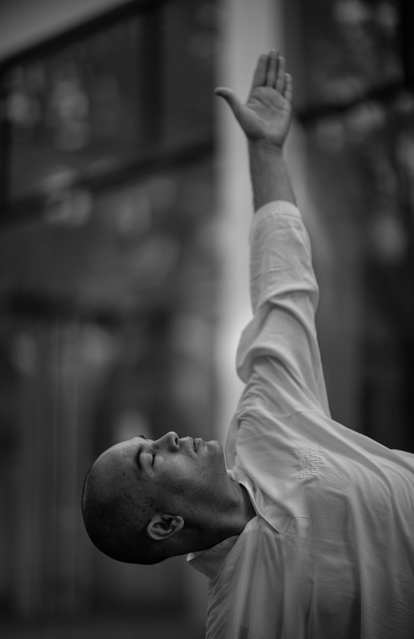 man in shirt with arm raised